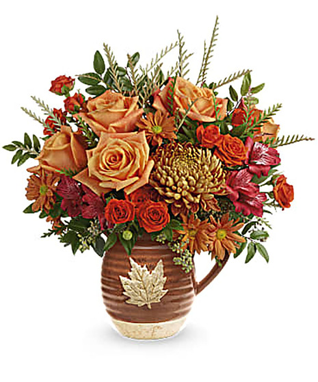 fall-toned flowers in large cascading bouquet with keepsake pitcher